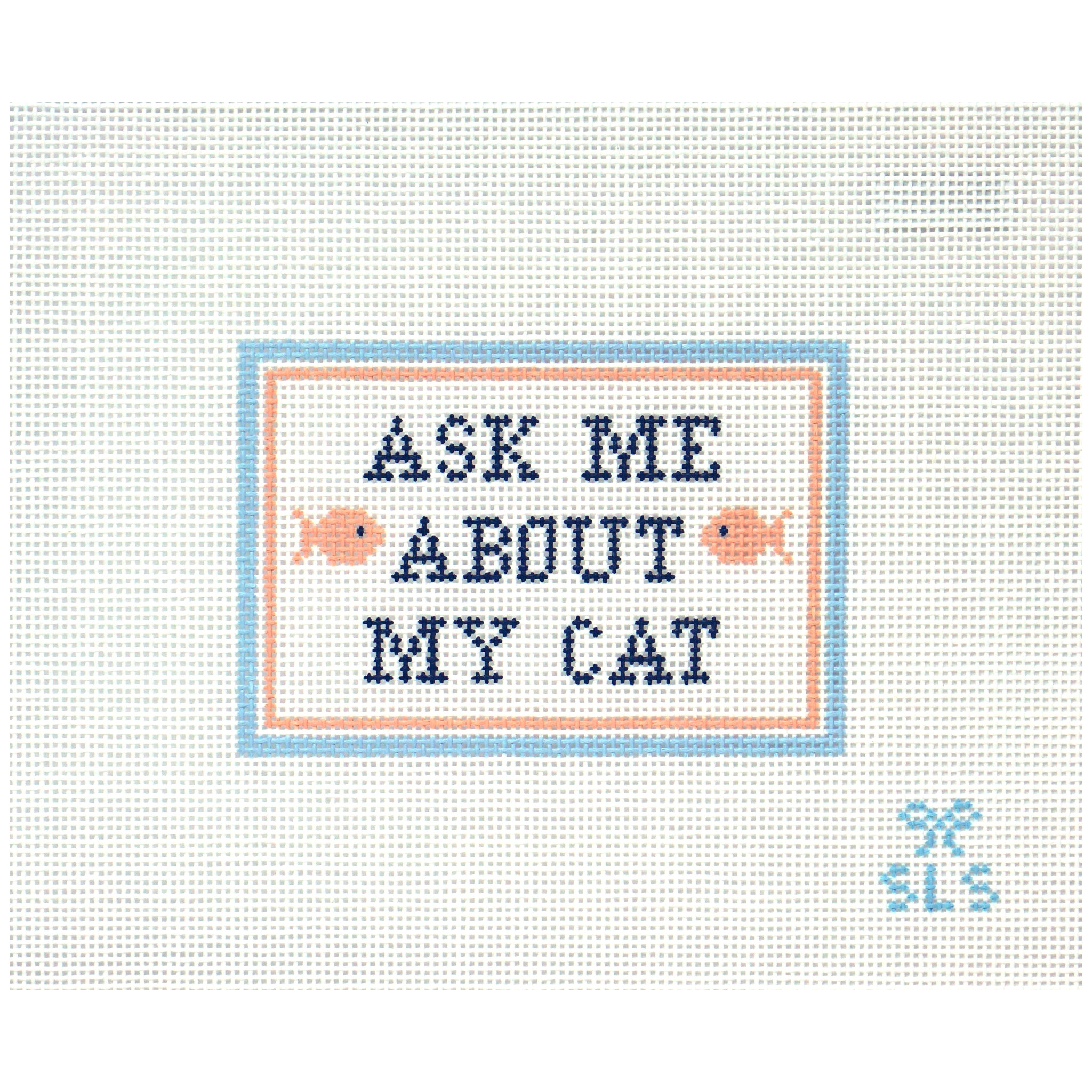 Needlepoint canvas with 'Ask Me About My Cat' text on a white background with coral fish.