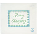 Needlepoint canvas with 'Baby Sleeping' text on a white background with scalloped edges