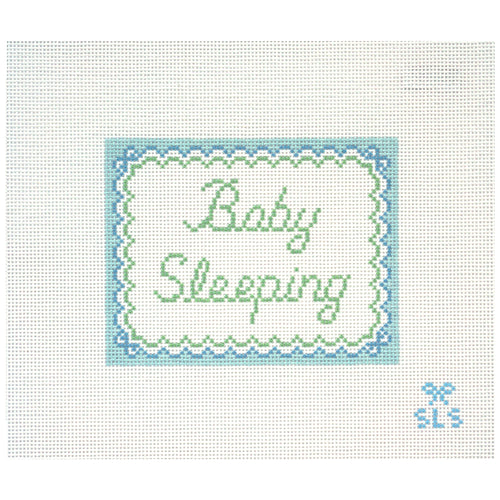 Needlepoint canvas with 'Baby Sleeping' text on a white background with scalloped edges