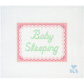 Needlepoint Canvas with 'Baby Sleeping' text on a white background and pink scalloped edges.