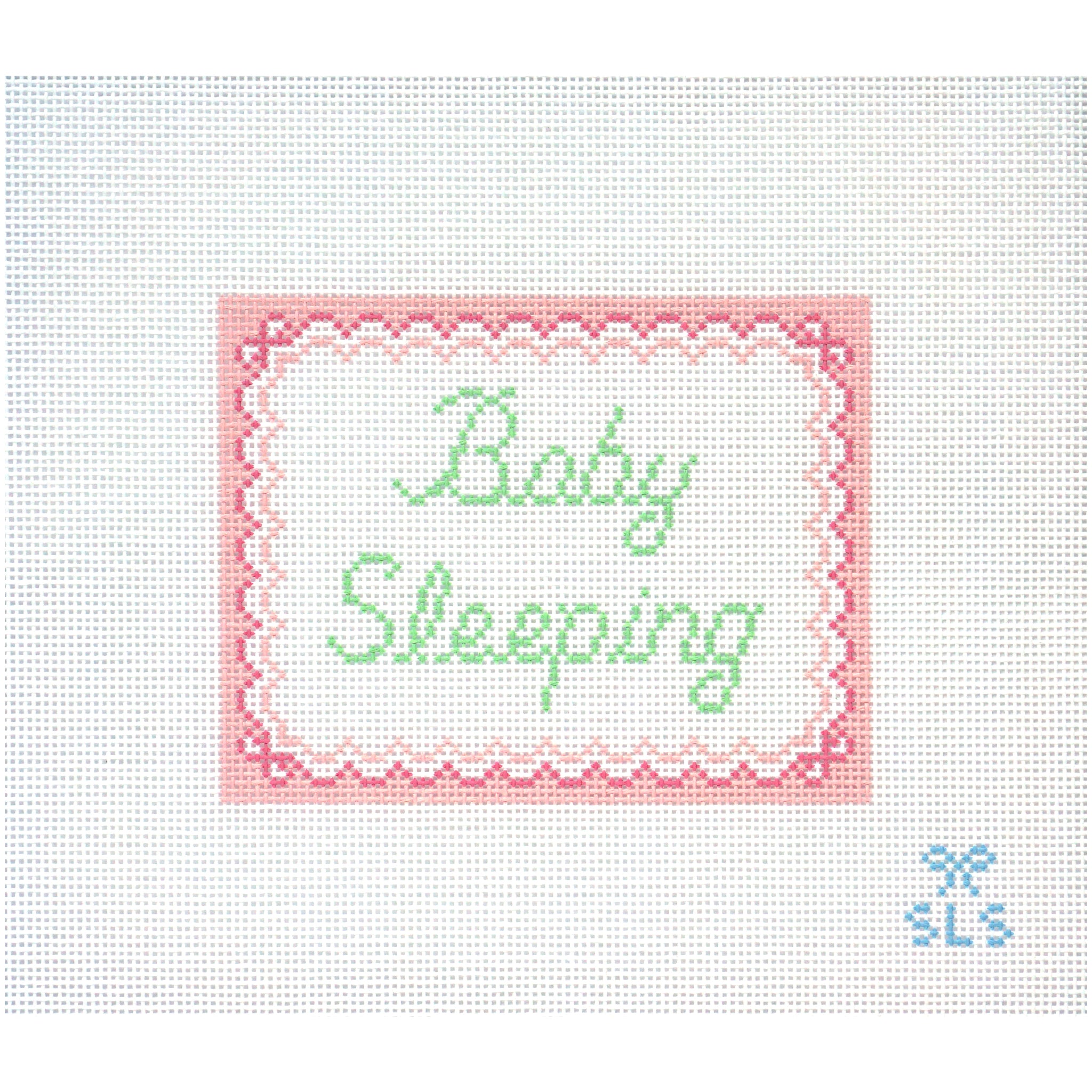 Needlepoint Canvas with 'Baby Sleeping' text on a white background and pink scalloped edges.