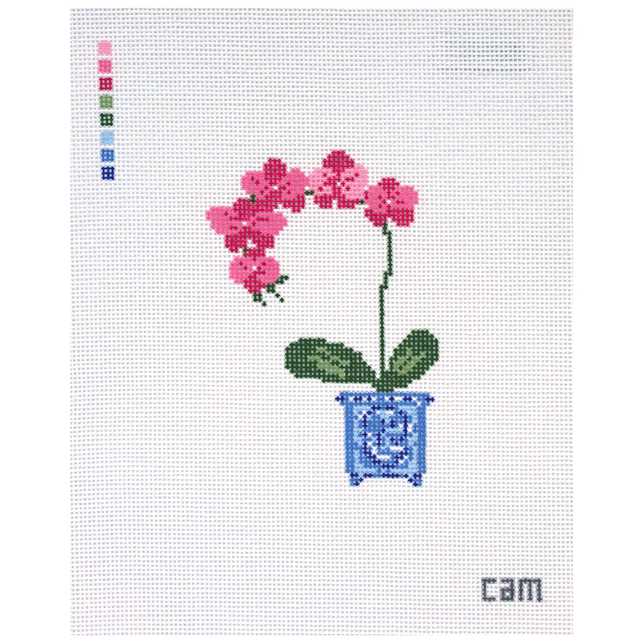 Needlepoint Canvas design of pink flowers in a blue pot on a white fabric background.