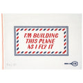 Needlepoint canvas with text 'I'm building this plane as I fly it' on a white background