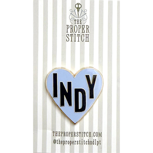 A needle minder design of a blue heart with the word "INDY" in the center to represent Indianapolis.