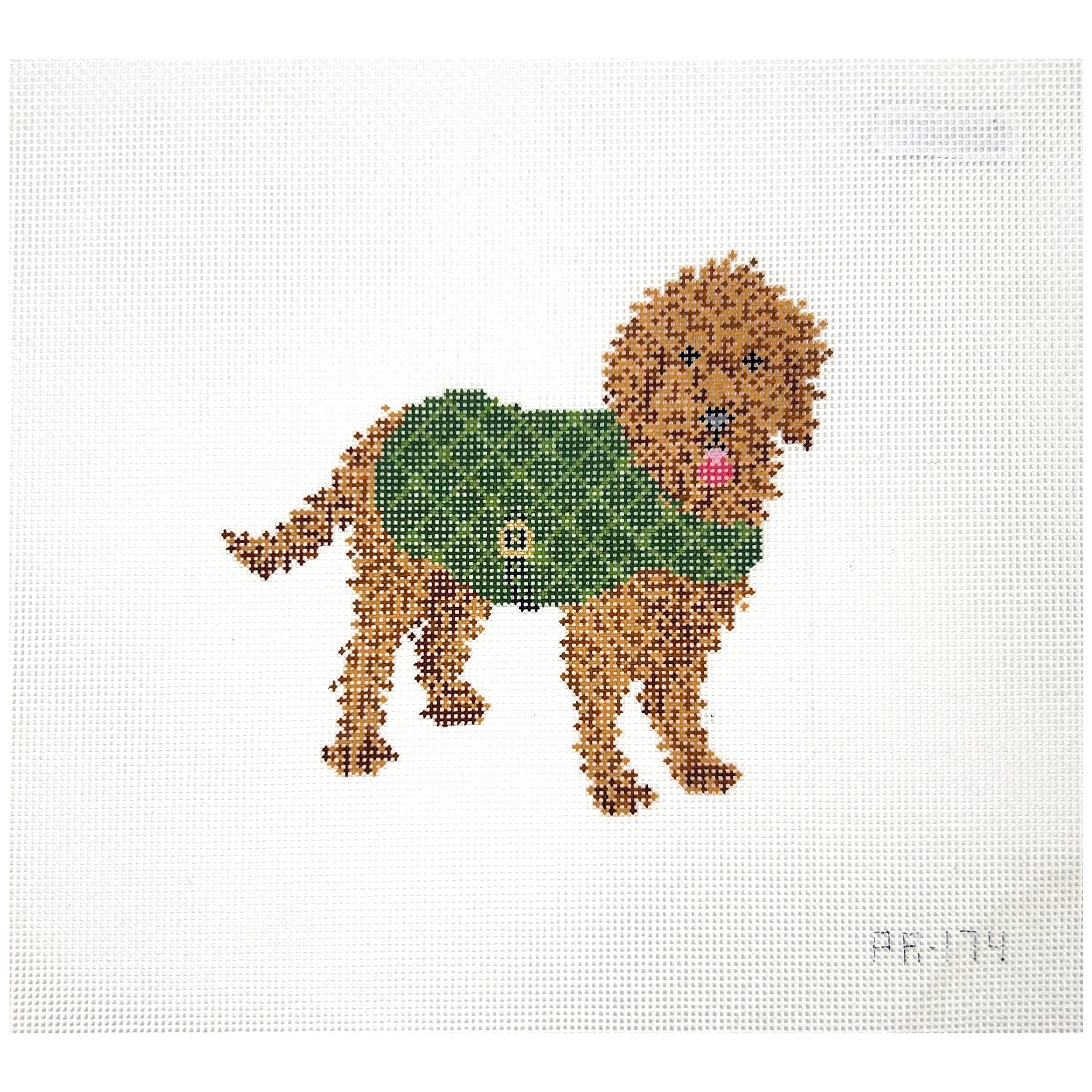 Needlepoint Canvas of a dog wearing a green sweater on a white background