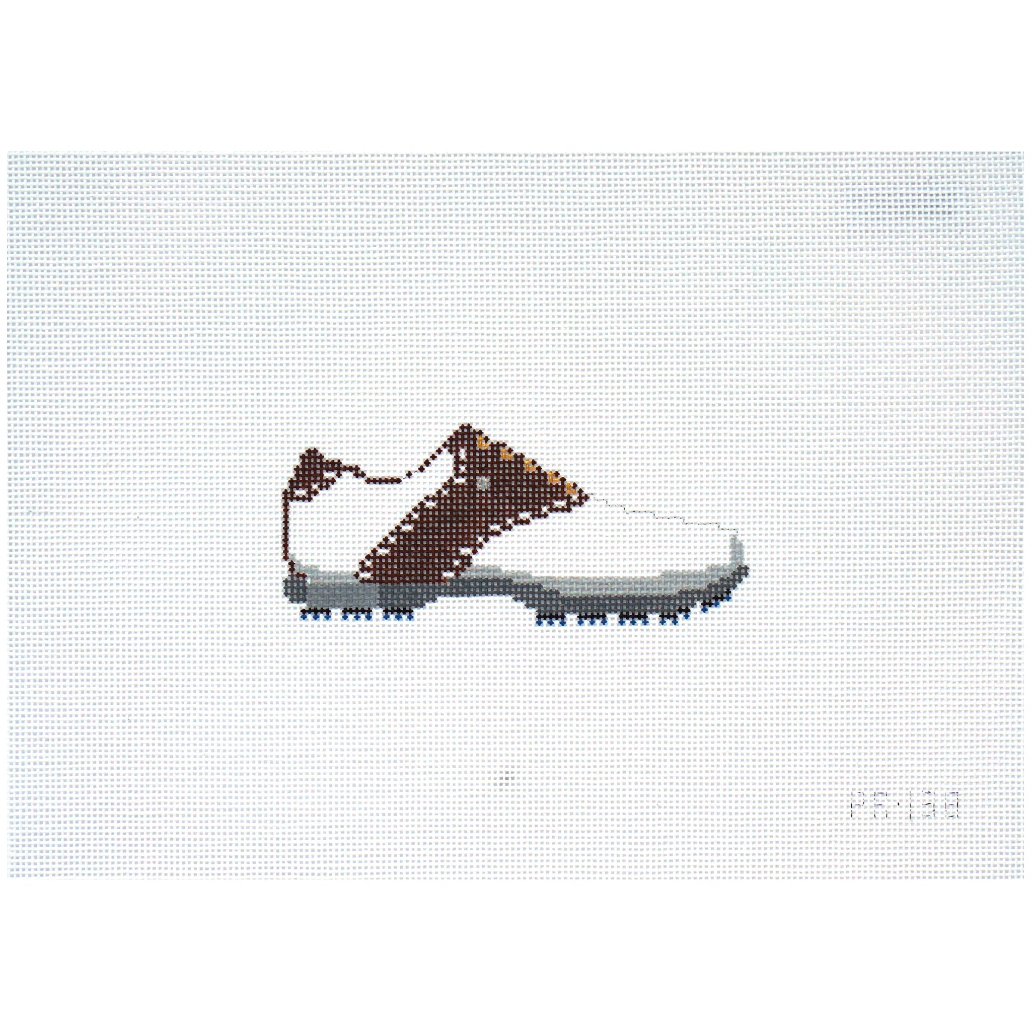 Needlepoint canvas of a white golf shoe with brown accents on a light gray background