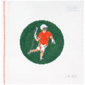 Needlepoint canvas of a lacrosse player in an orange jersey on a green circle with a white background.