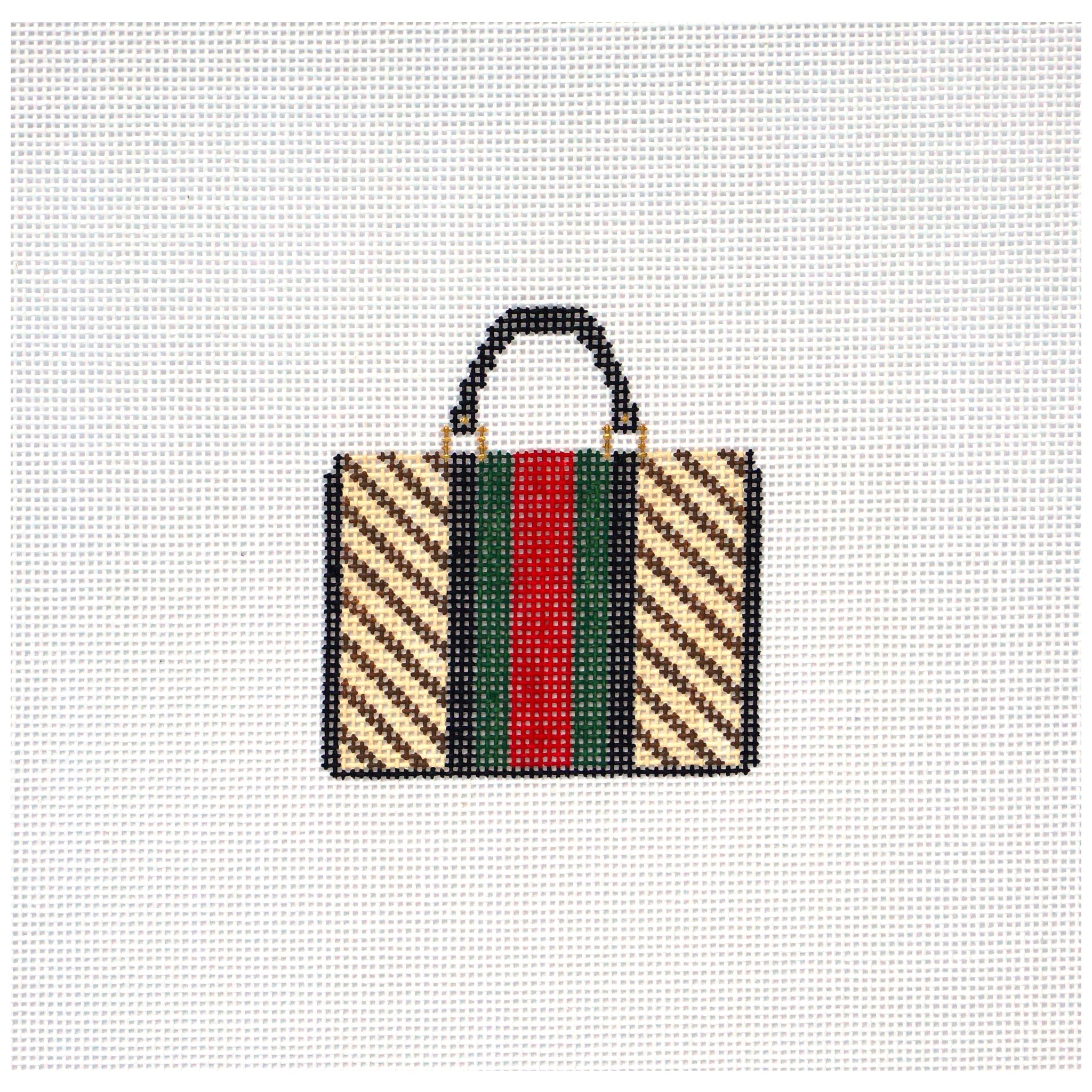 Needlepoint canvas design of a handbag with a colorful pattern on a white background