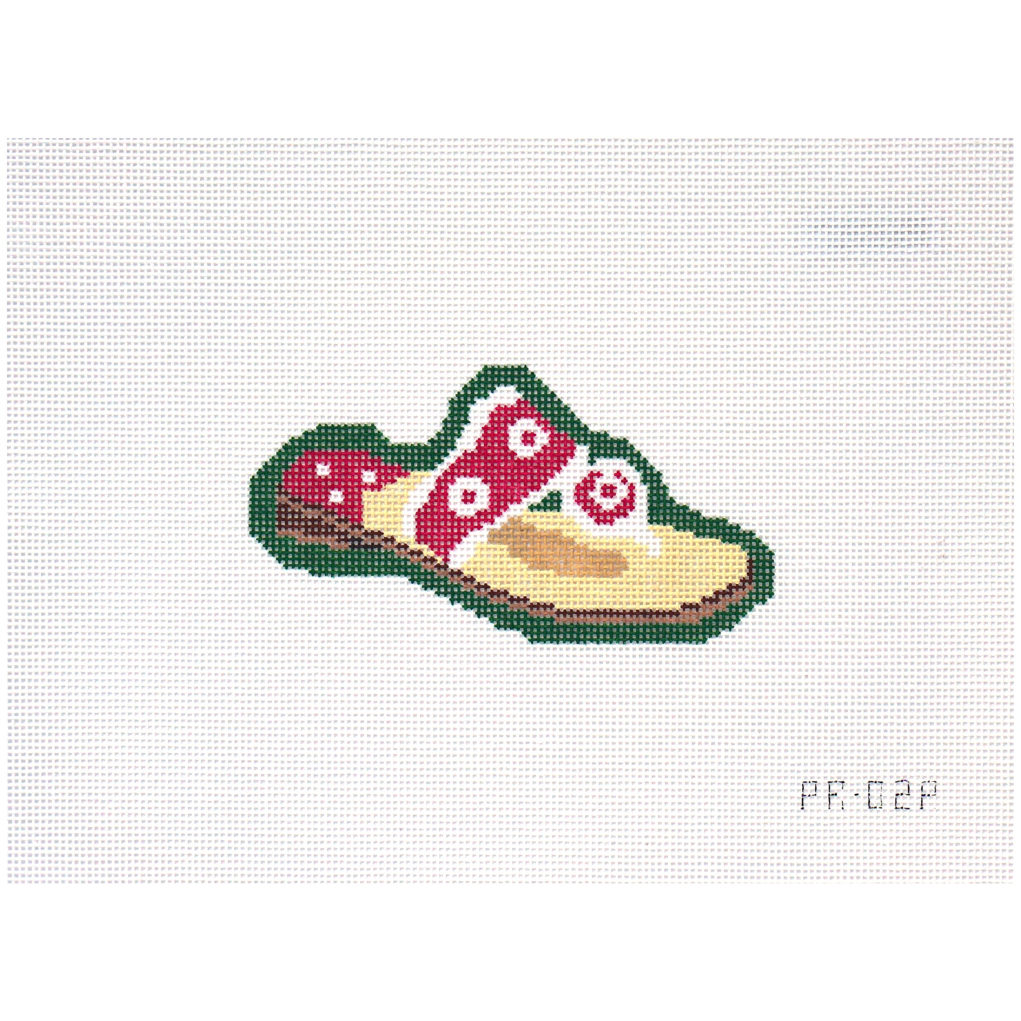 Needlepoint canvas of a pink sandal on a green background