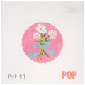 Needlepoint canvas of flowers and a bow on a pink circle