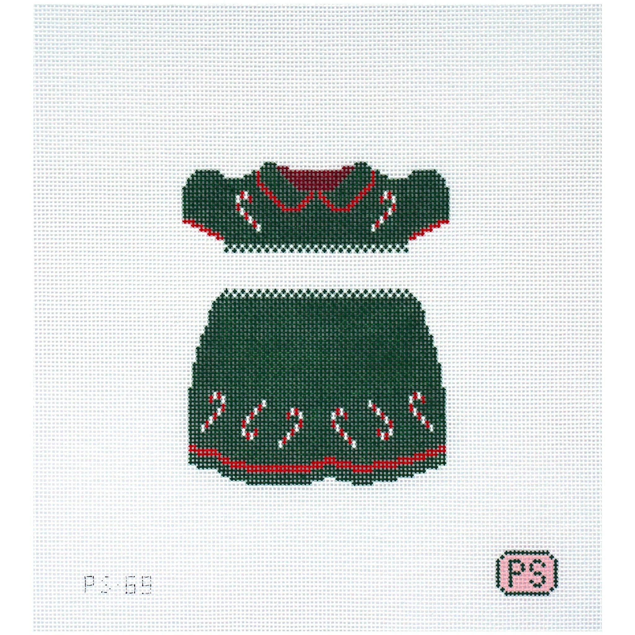 Needlepoint canvas of a green dress with candy cane details on a white background