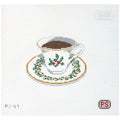 Needlepoint canvas design of a teacup and saucer with holly decorations on a white background.