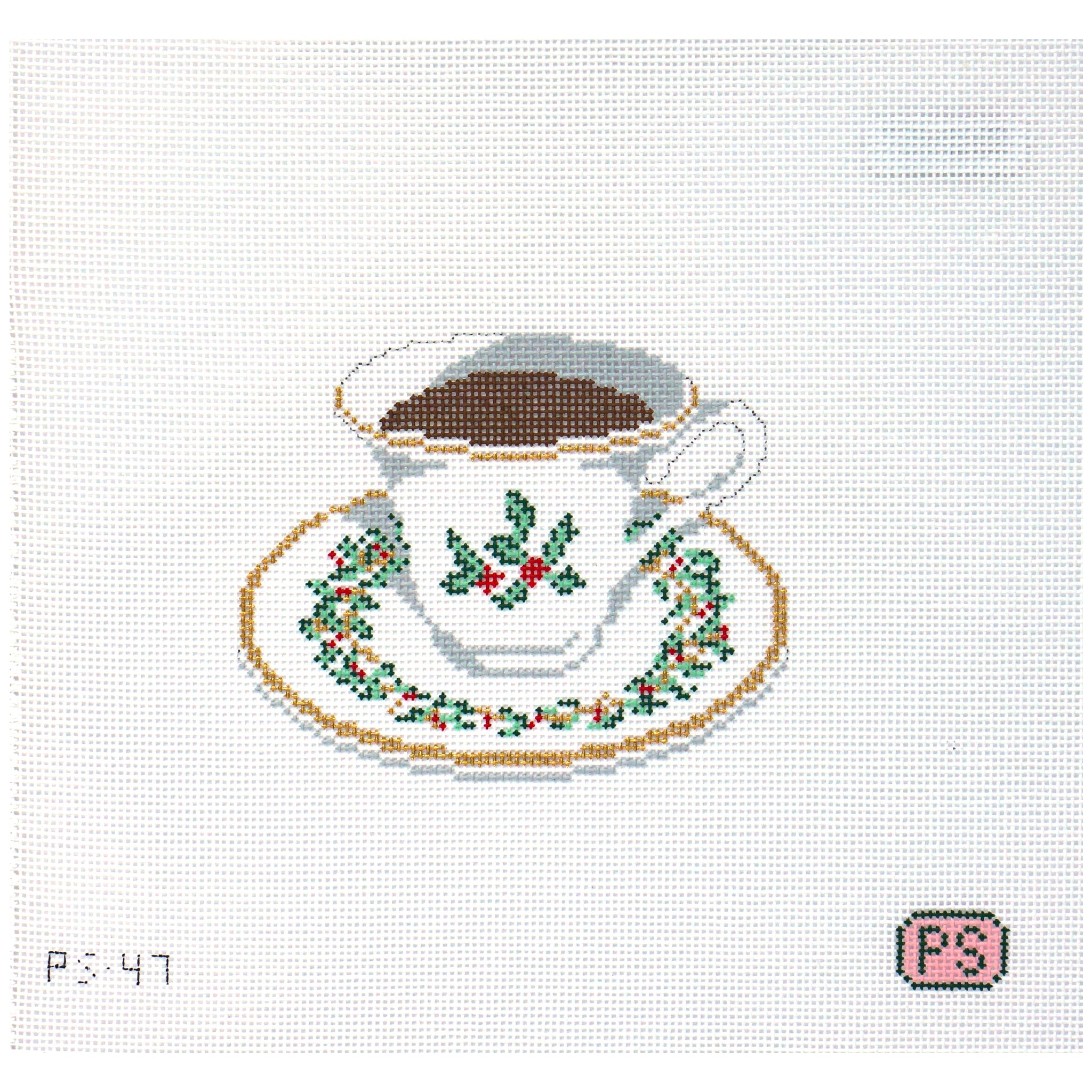 Needlepoint canvas design of a teacup and saucer with holly decorations on a white background.